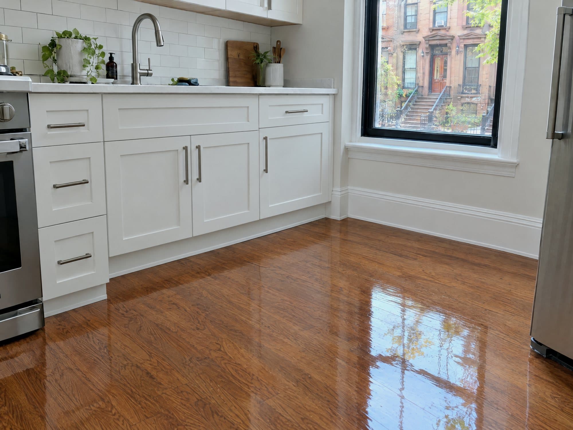 The same kitchen restored: dry refinished floor and a rebuilt sink cabinet