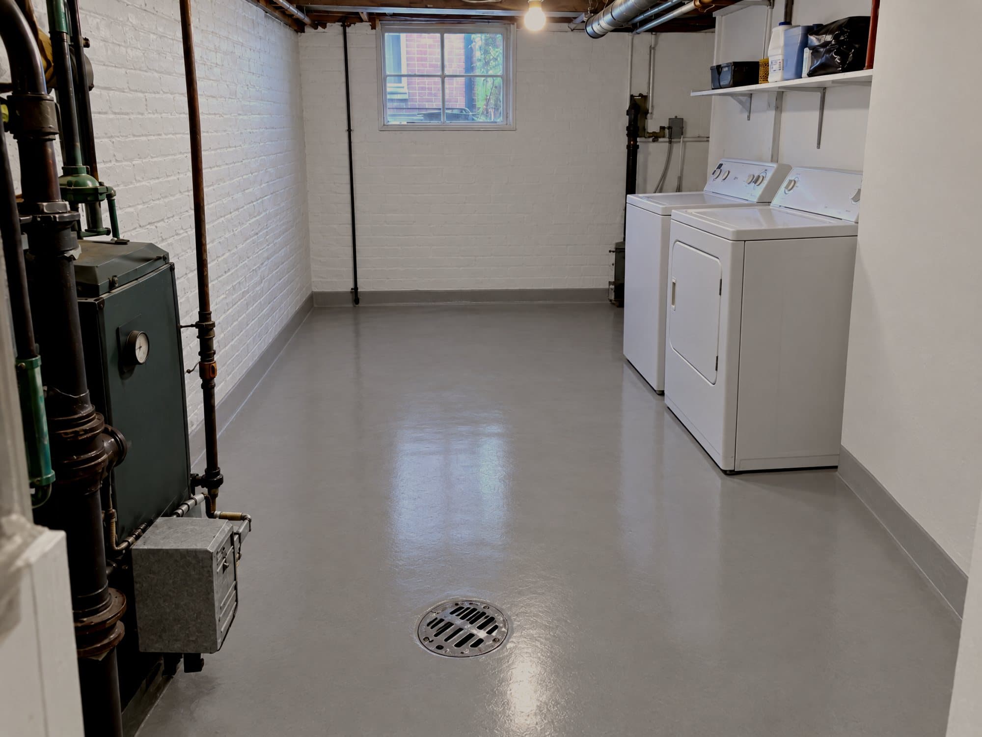 The same basement cleaned and disinfected: dry sealed floor and freshly painted walls